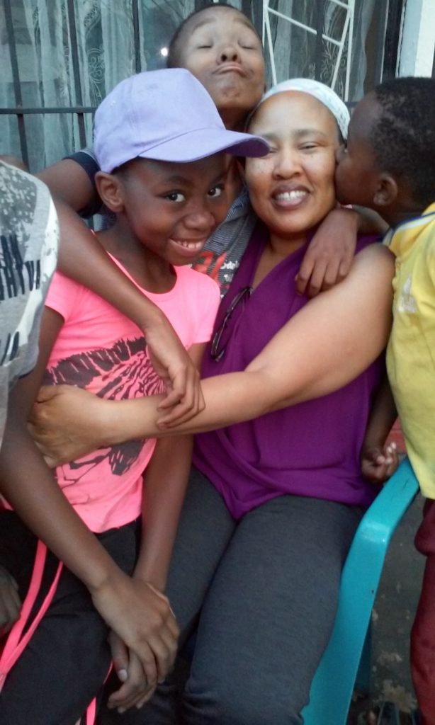 Portia (in purple) shares a hug with three of her kids. 