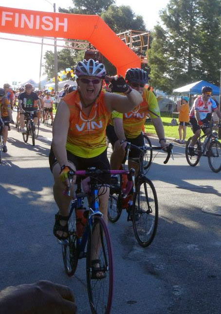 Dr. Kathy Anderson (far left), with her husband Howie just behind her, crosses the finish line at the Bike MS: Historic New Bern. 2017 will be the 14th year Kathy has raised funds to fight MS by participating in the charity ride.
