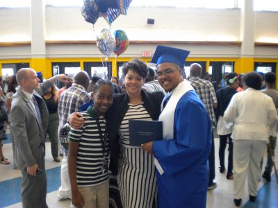 Camille (middle) celebrates the graduation of her son (right).