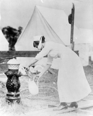 A Red Cross nurse draws water at a military camp in Brookline, Mass., in 1918. (Photo courtesy of U.S. National Archives)