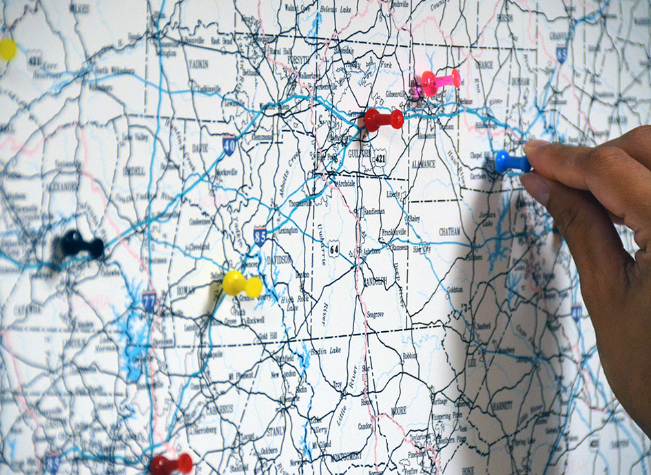 A member of NCIPH places a pin on the North Carolina map.