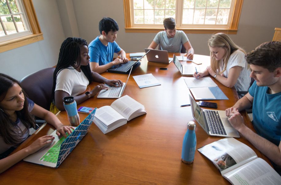 Students study in a conference room.