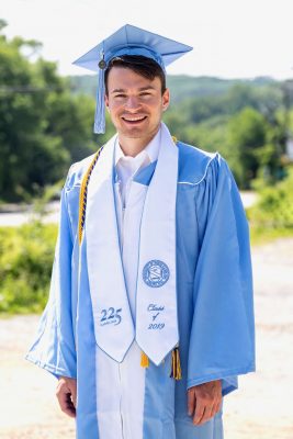 Kevin Travia in UNC graduation robes.