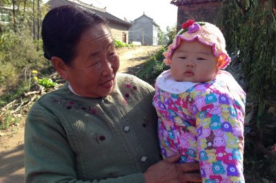 A grandmother holds a baby in a rural Chinese village. (Photo courtesy of Dr. Sean Sylvia)