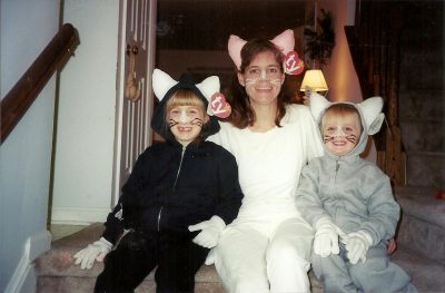 Two children and one adult dressed in cat Beanie Babies costumes.