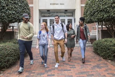 (From left) Samuel Baxter, a third year PhD student in health policy, Sarah Zelasky, a senior majoring in environmental health, Abhinav Sehgal, a senior majoring in nutrition, Dharitri Shah, a second year graduate student, and Jeliyah Clark, a senior majoring in environmental health sciences, walk out of Rosenau Hall at the UNC Gillings School of Global Public Health on March 1, 2018, in Chapel Hill. (Johnny Andrews/UNC-Chapel Hill)