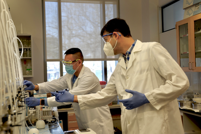 Postdoctoral associate Guan Pin "Nick" Chew, left, joins Orlando Coronell in the lab. (Photo by Jennie Saia)