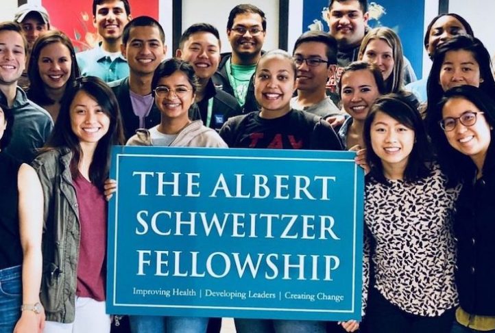Fellows pose with a sign for the Albert Schweitzer Fellowship.