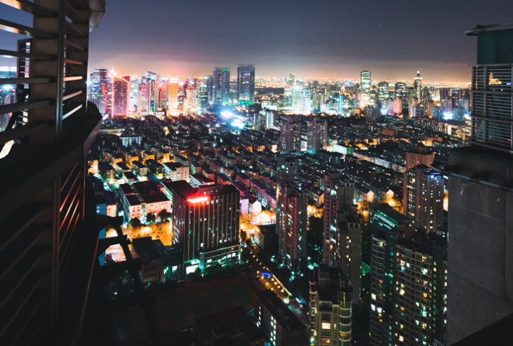 Buildings in the skyline across Shanghai, China illuminate the night.