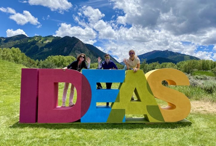 From left to right: Dr. Leah Devlin, Naya Villarreal and Mary Willoughby pose by the Aspen Ideas sign.