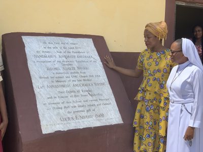 Ada (at left) views the inscription at the canteen her father dedicated to her.