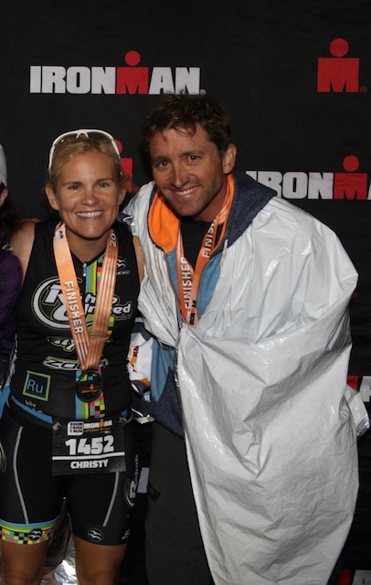 Christy England smiles with her husband after completing the Ironman triathlon.