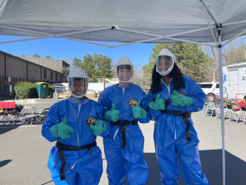 Three Gillings on the Ground participants give a thumbs up in their protective gear.