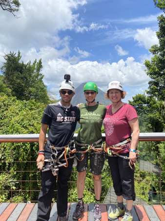 Katherine, her partner, Valarie Hines, and her son, Jaidan Turner-Lowry, ascend a mountain overlooking Arenal Volcano in Costa Rica.