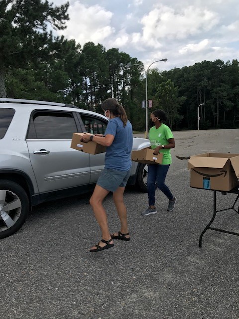 Nash County high school students hand out produce boxes, masks and hand sanitizer at a drive-through.