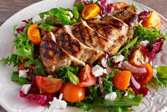 Grilled chicken tops a fresh salad.
