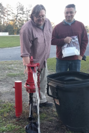Jefferson Currie and Dr. Andrew George take water samples from a well in Robeson County. 